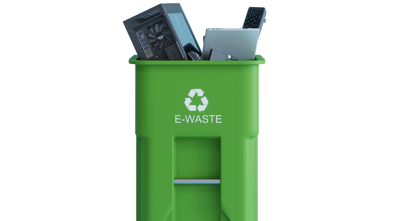 Green e-waste recycling bin filled with a desktop tower, laptop, keyboard and monitor